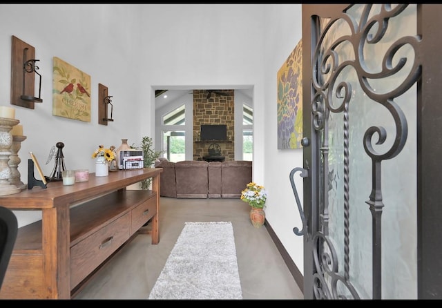 entryway featuring a fireplace and vaulted ceiling