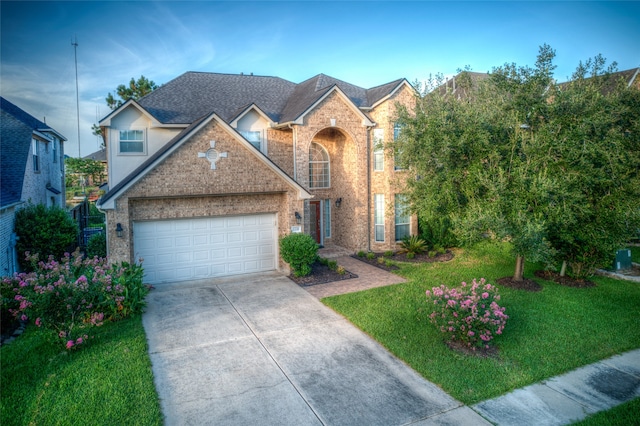 front facade featuring a garage and a front yard