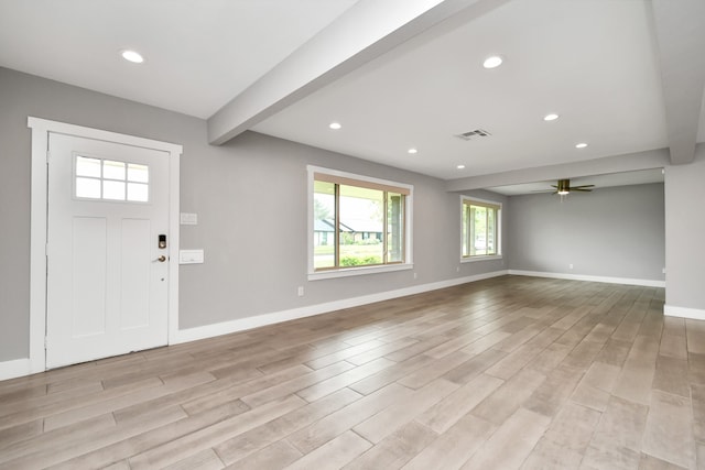 foyer with beam ceiling, light hardwood / wood-style flooring, and ceiling fan