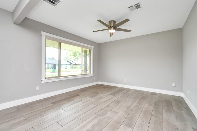 unfurnished room featuring beamed ceiling, ceiling fan, and light wood-type flooring