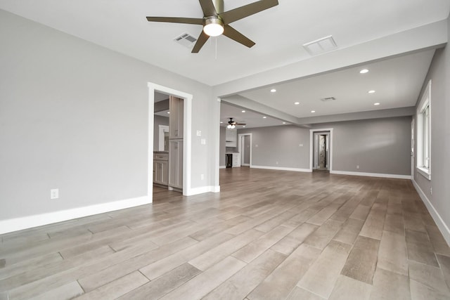 unfurnished living room featuring ceiling fan and light hardwood / wood-style floors