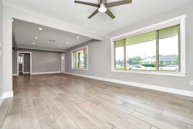 unfurnished room with ceiling fan and light wood-type flooring