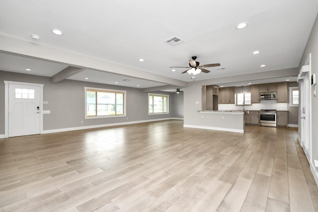 unfurnished living room with ceiling fan and light wood-type flooring