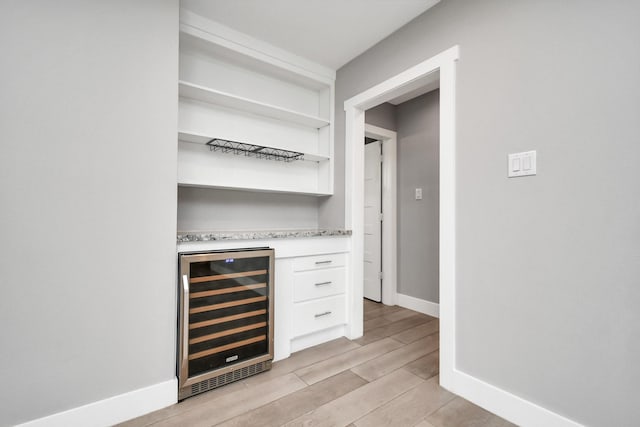 bar with wine cooler and white cabinets