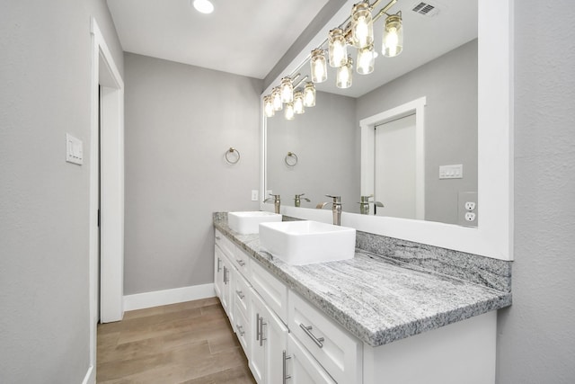 bathroom with vanity and wood-type flooring