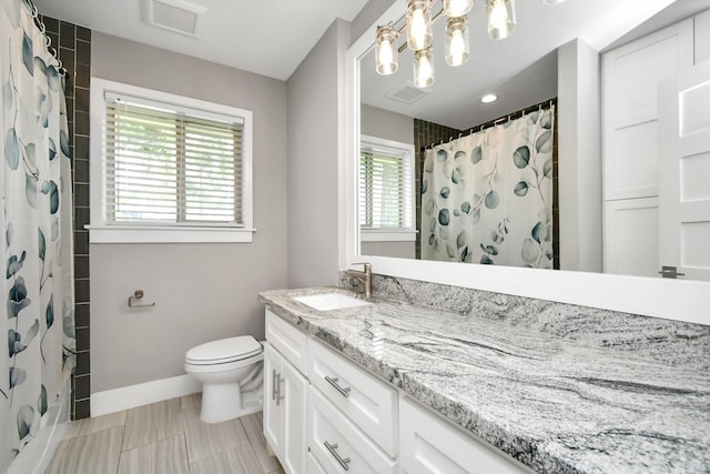 bathroom with vanity, toilet, and a shower with shower curtain