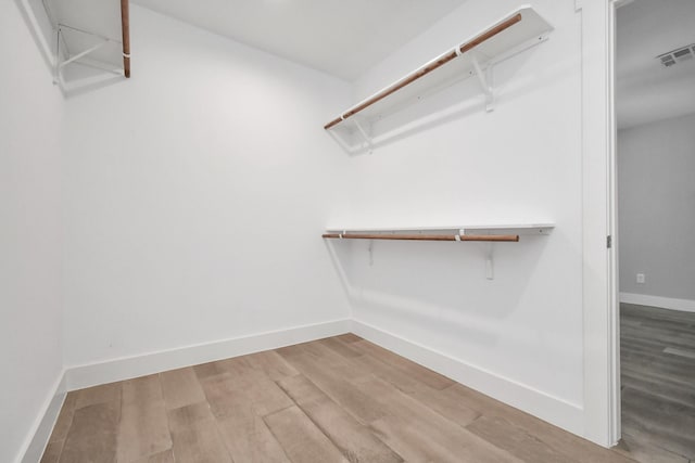 spacious closet featuring hardwood / wood-style floors