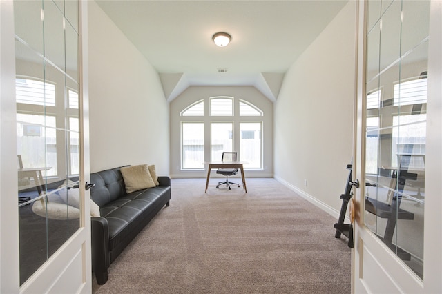 living room with lofted ceiling and light colored carpet