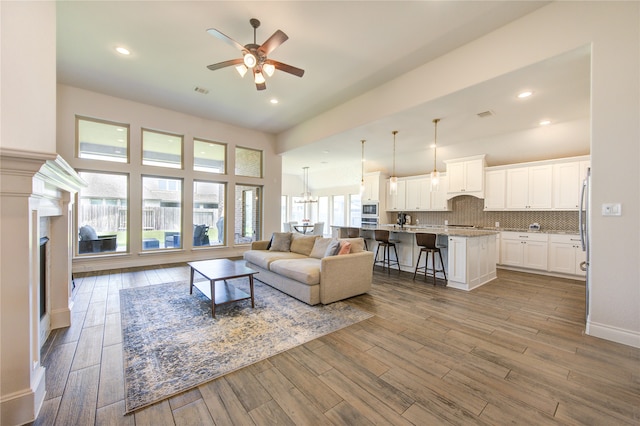 living room featuring hardwood / wood-style flooring and ceiling fan