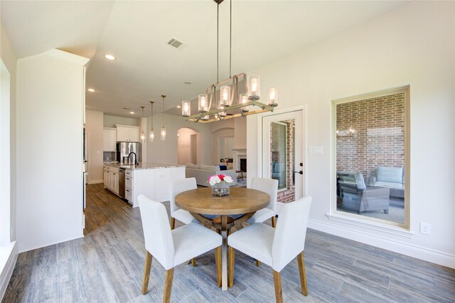 dining space with wood-type flooring