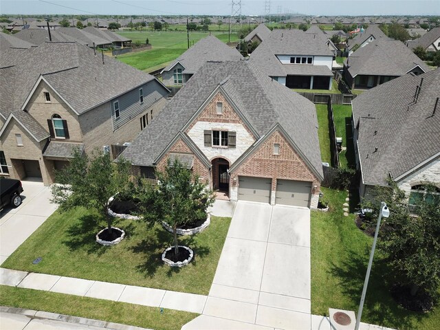 view of front of home with a front lawn and a garage