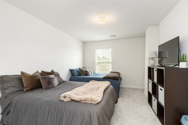 bedroom featuring light colored carpet