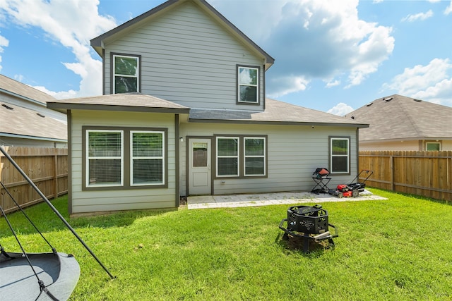 back of house featuring a yard