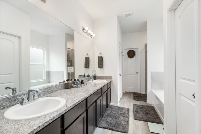 bathroom featuring a bathtub, hardwood / wood-style floors, and vanity