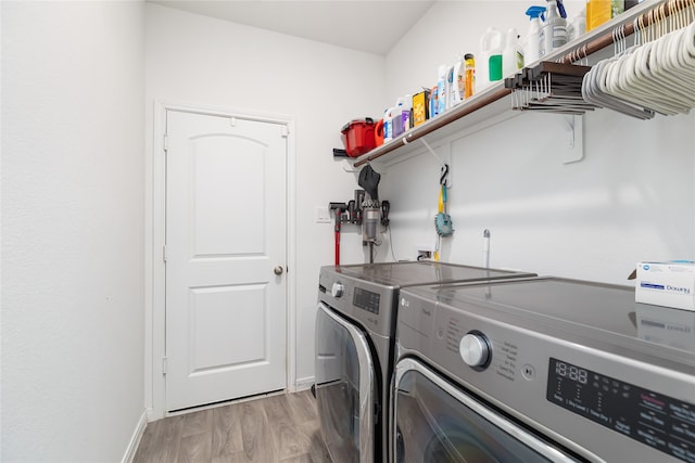 washroom with hardwood / wood-style flooring and independent washer and dryer