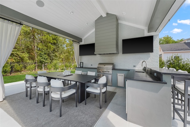 view of patio / terrace with exterior kitchen, sink, and a grill