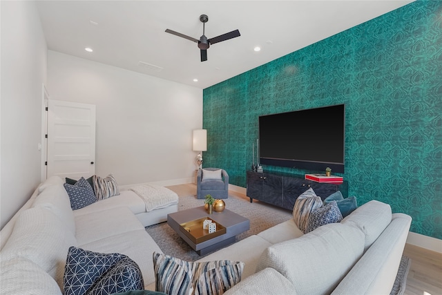 living room with ceiling fan and wood-type flooring