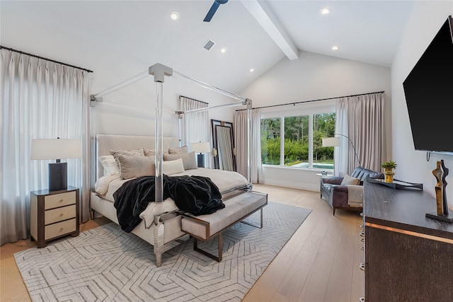 bedroom with light hardwood / wood-style floors, ceiling fan, and vaulted ceiling with beams