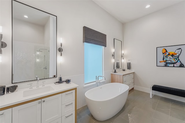 bathroom with tile patterned floors, double sink vanity, and a shower