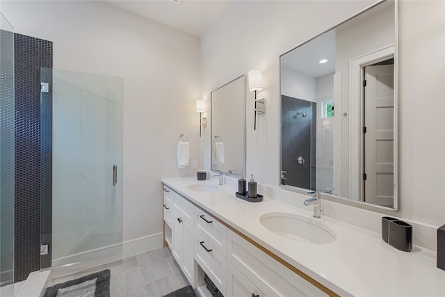 bathroom with tile patterned floors, an enclosed shower, and dual bowl vanity