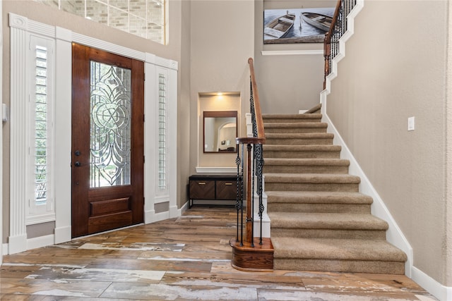 entrance foyer with hardwood / wood-style flooring and a healthy amount of sunlight