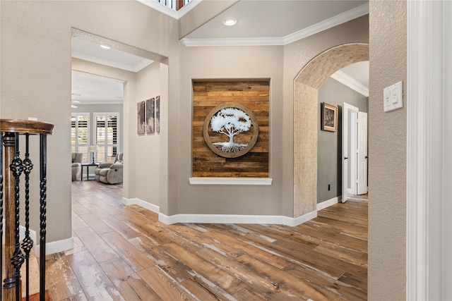 corridor with wood-type flooring and crown molding