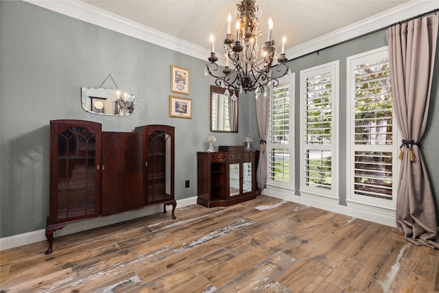 misc room with an inviting chandelier, a healthy amount of sunlight, hardwood / wood-style floors, and crown molding