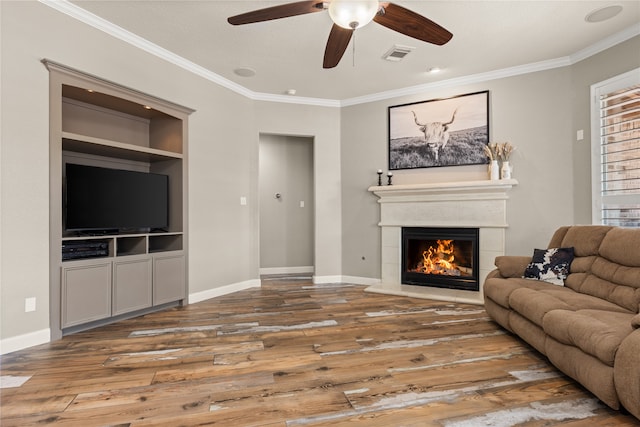 living room featuring ornamental molding, wood-type flooring, and ceiling fan