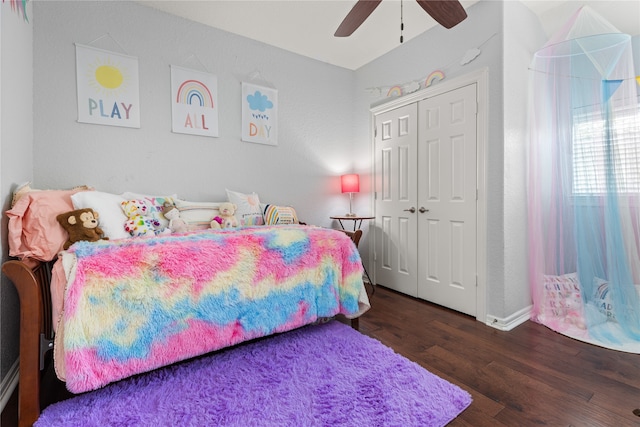 bedroom with a closet, dark hardwood / wood-style floors, and ceiling fan