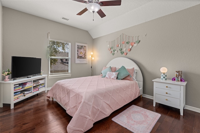 bedroom featuring ceiling fan, dark hardwood / wood-style floors, and vaulted ceiling