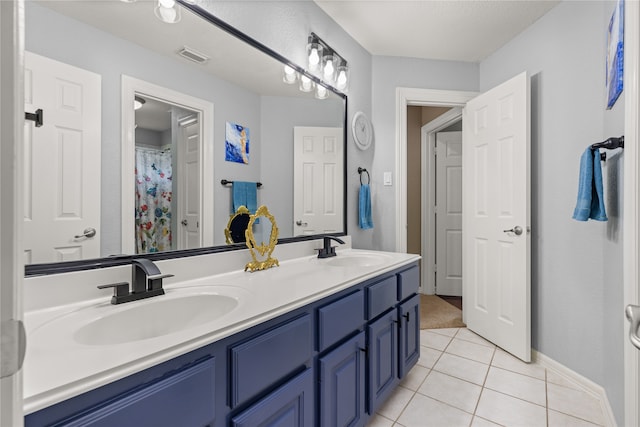 bathroom featuring tile patterned flooring and vanity