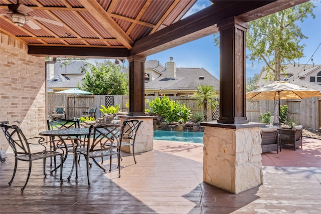 view of patio / terrace featuring ceiling fan, a fenced in pool, a gazebo, and pool water feature