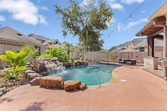 view of pool with pool water feature and a patio