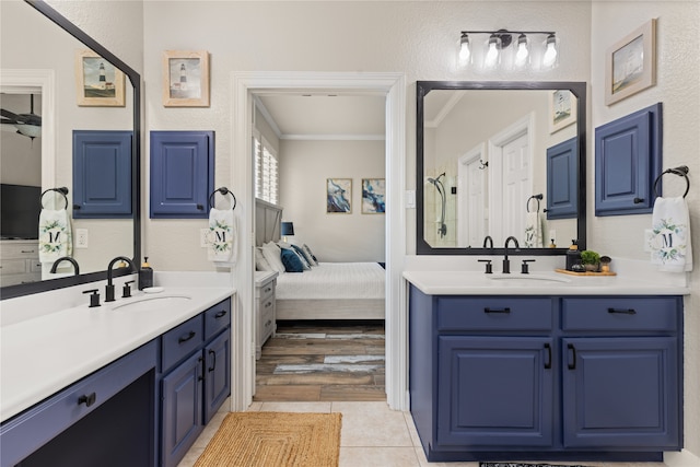 bathroom featuring wood-type flooring, vanity, and ornamental molding