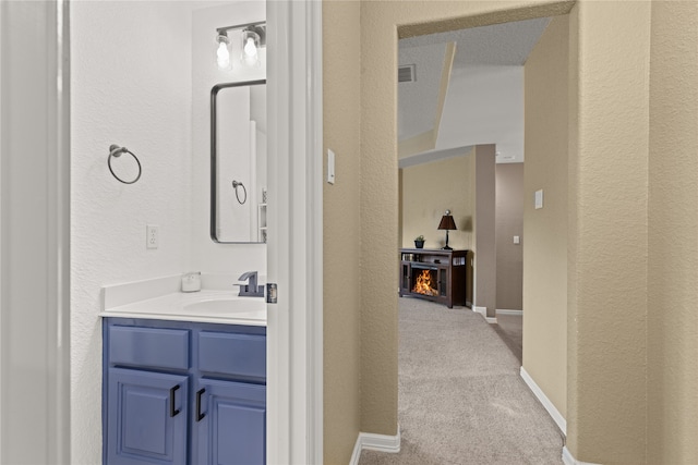 bathroom with vanity and a textured ceiling