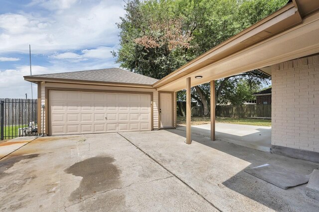 detached garage featuring fence