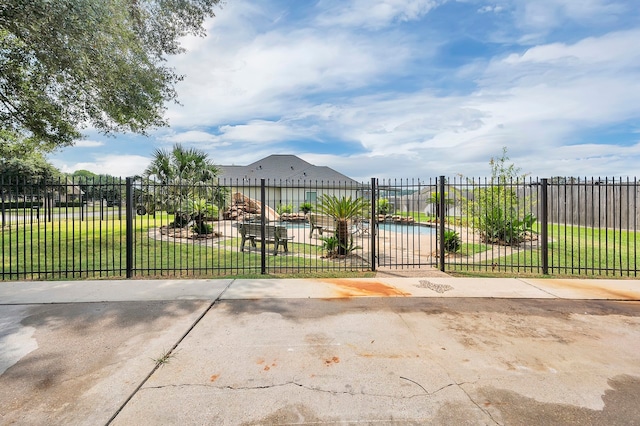 view of gate featuring a lawn