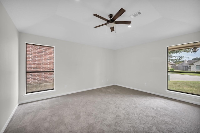 carpeted spare room featuring recessed lighting, visible vents, baseboards, and ceiling fan