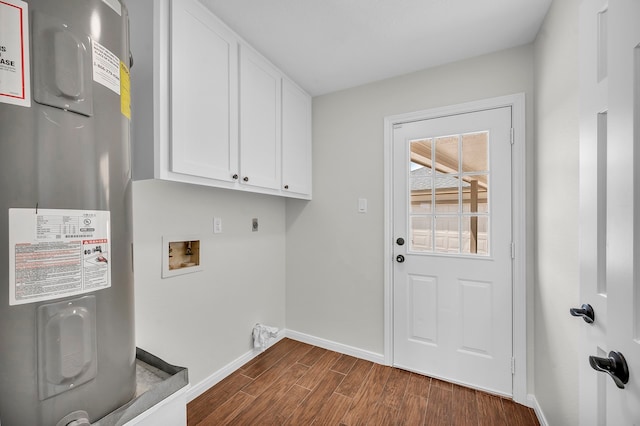 laundry area featuring electric dryer hookup, dark hardwood / wood-style flooring, water heater, washer hookup, and cabinets