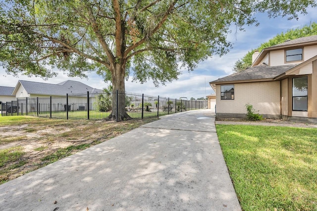 exterior space with a yard, brick siding, and fence