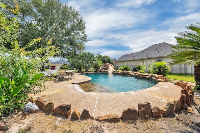 view of pool featuring a patio area and a water slide