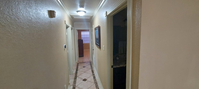 hall with light tile patterned flooring and crown molding