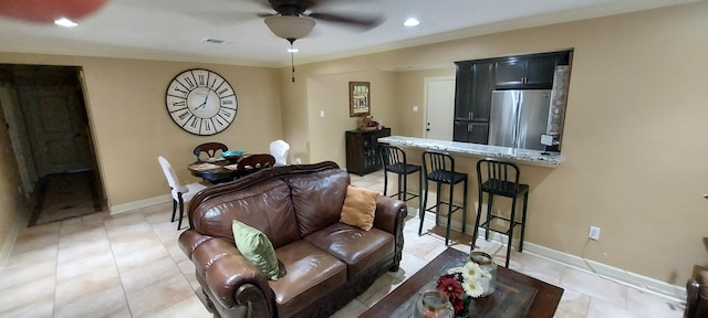 living room featuring crown molding, ceiling fan, and light tile patterned floors