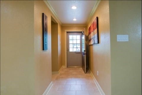 interior space featuring crown molding and light tile patterned floors