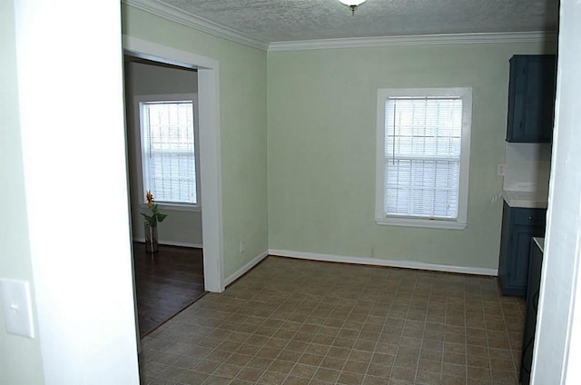 interior space with ornamental molding, dark tile patterned floors, and a wealth of natural light