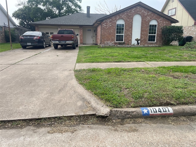 view of front of home featuring a garage and a front lawn