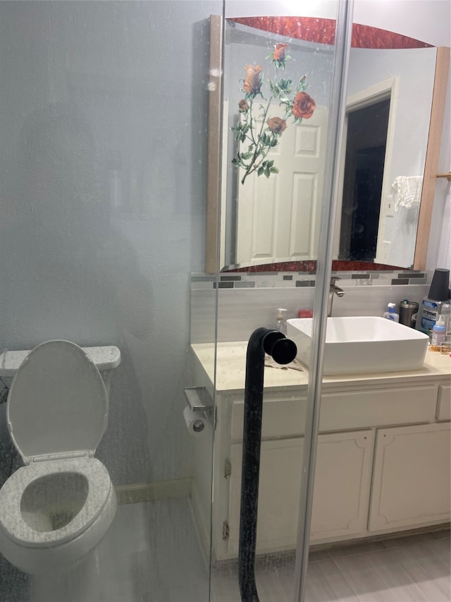 bathroom with tile patterned floors, toilet, and vanity