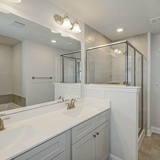 bathroom with shower with separate bathtub, tile patterned flooring, and dual bowl vanity