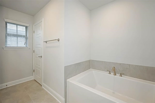 bathroom featuring tile patterned flooring and a bath