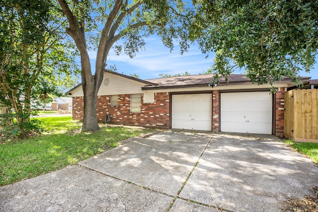 ranch-style home featuring a front yard and a garage